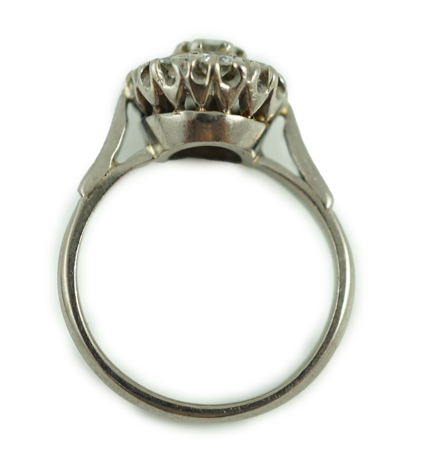 An 18ct white gold and nine stone diamond flower head cluster ring
